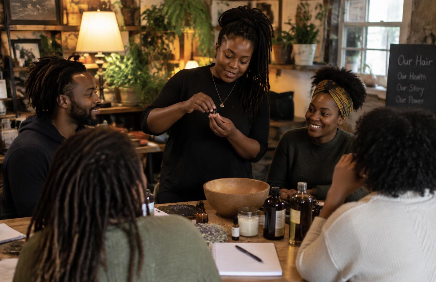Community hair care workshop gathered around a table